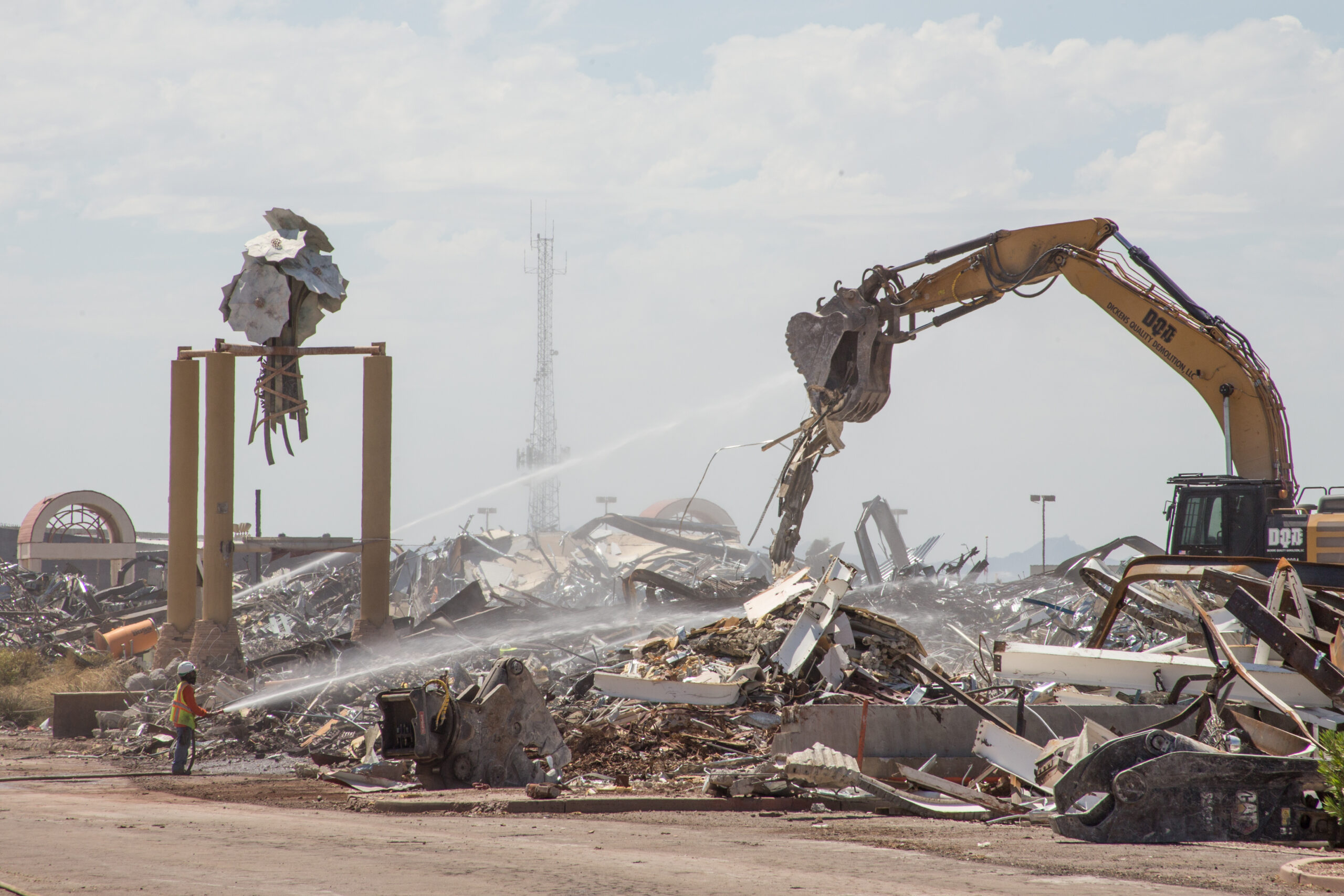 Construction crews use a water cannon to contain the dust created by an excavator demolition of Fiesta Mall in Mesa, as seen on August 31, 2023. (Photo by Rey Covarrubias Jr.)