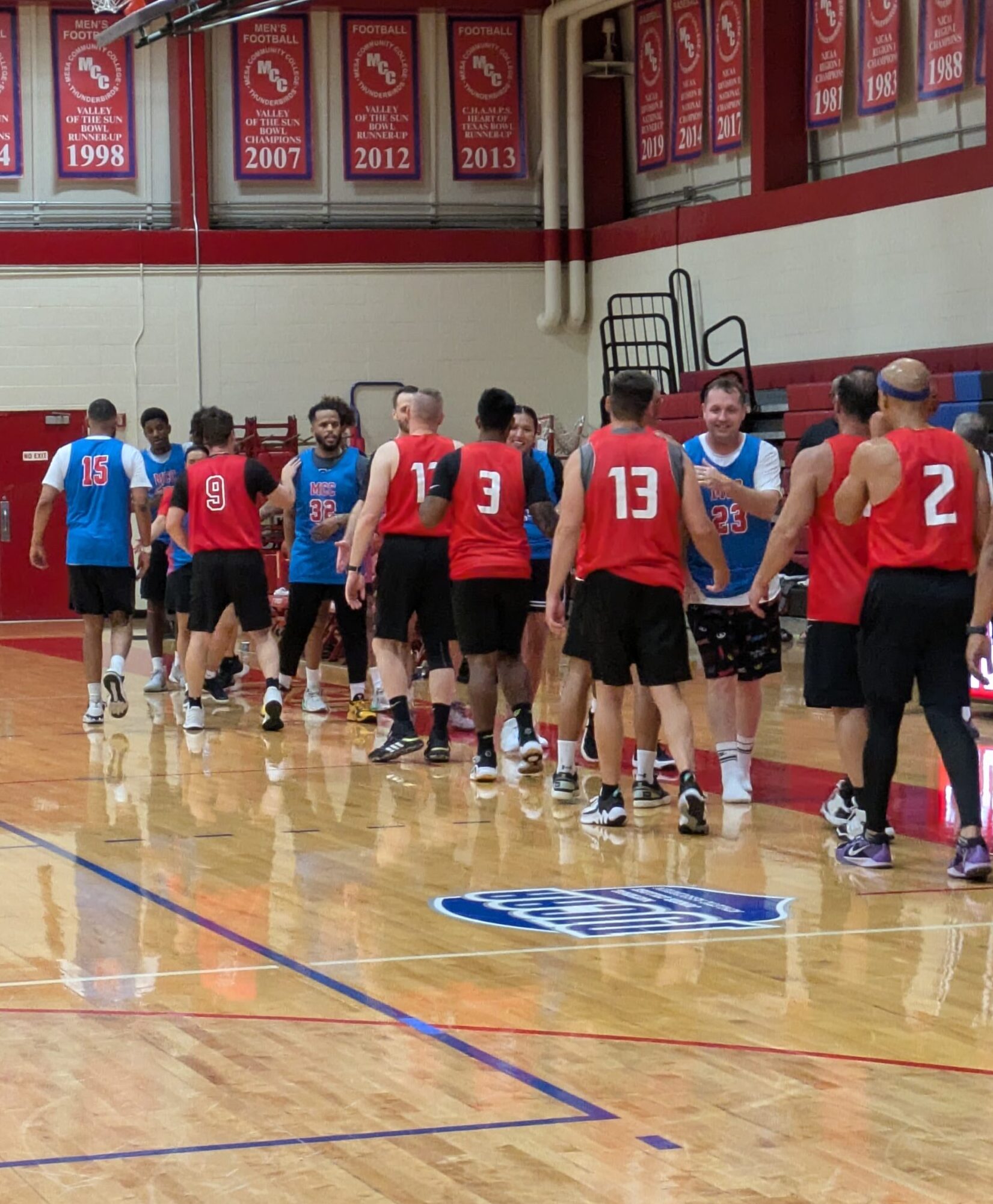 Alumni and law enforcement shaking hands after their game for the Mesa Basketball Benefit at Mesa Community College's Southern and Dobson Campus on October 11, 2024. (Photo by Riley Weathersbee/ The Mesa Legend)