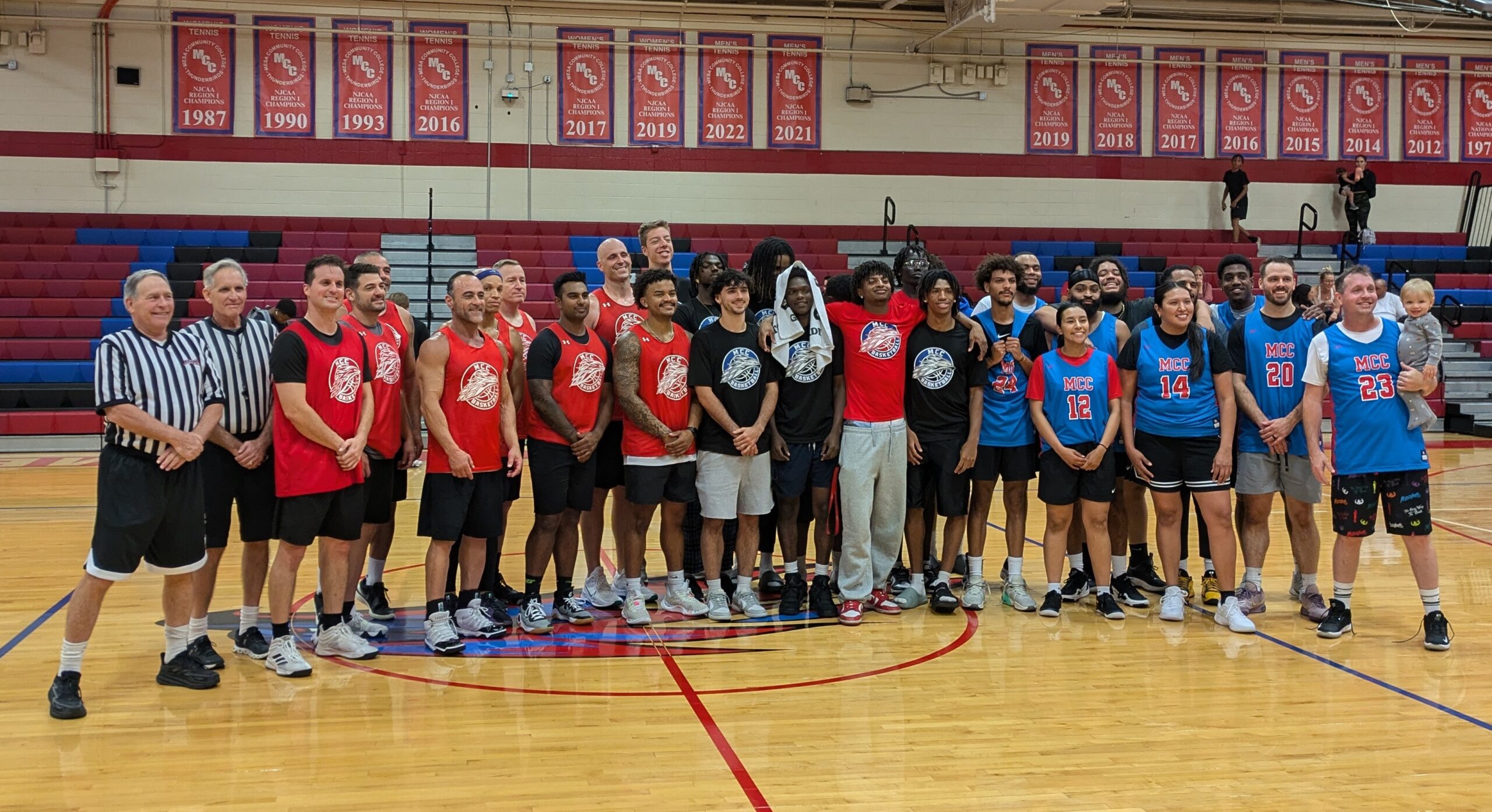 Alumni, MCC basketball teams, law enforcement, and community members posing for a group picture after their game for the Mesa Basketball Benefit at Mesa Community College Southern and Dobson Campus on October 11, 2024. (Photo by Riley Weathersbee/The Mesa Legend)