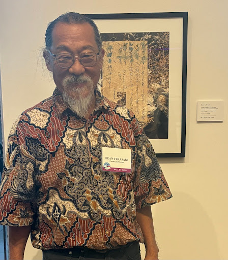 Former MCC professor Dean Terasaki with one of his photomontages featured in the “Legacy in Motion” alumni exhibit at the college’s art gallery during the “Hall of Fame” event on Oct. 23. Photo by Jasmine Kageyama/The Legend