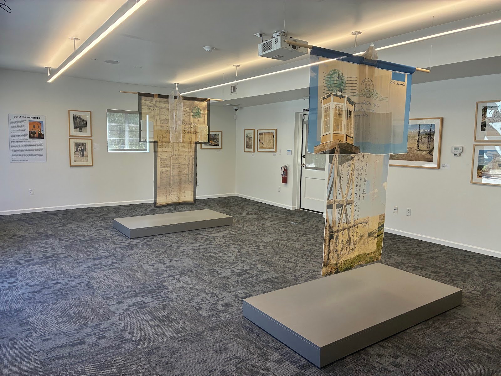 Two sheer kimonos made by Terasaki and his wife stand in the center of the exhibit and reflect the imagery of two featured photomontages. Photo by Jasmine Kageyama/The Legend